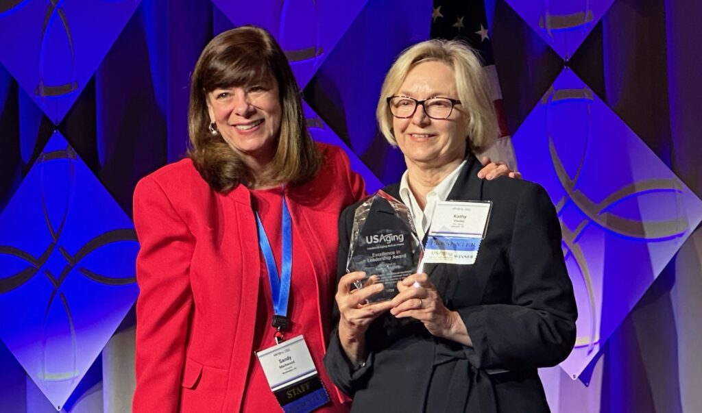 Two woman one holding award