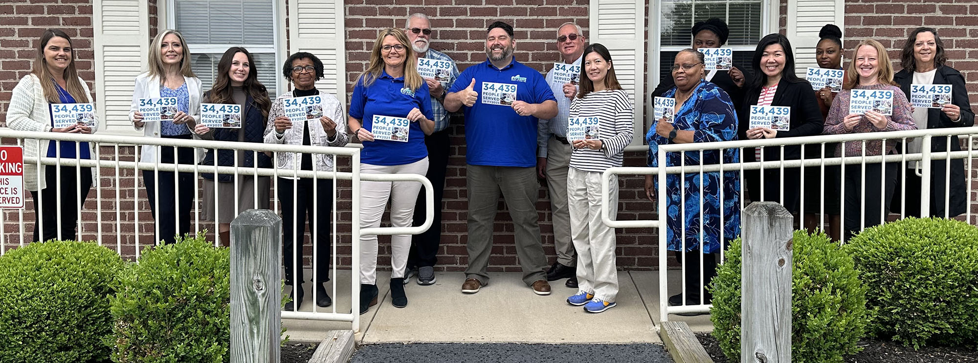 group in front of building holding pamphlets