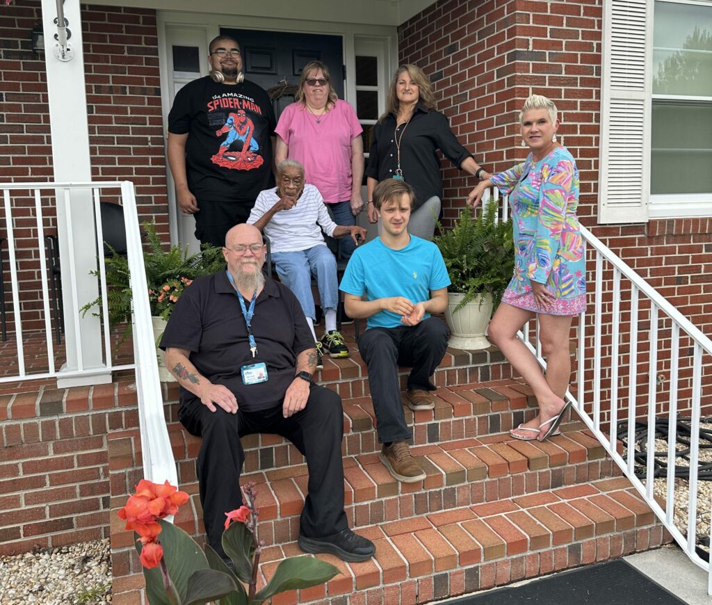 Group of people standing on steps in front of building