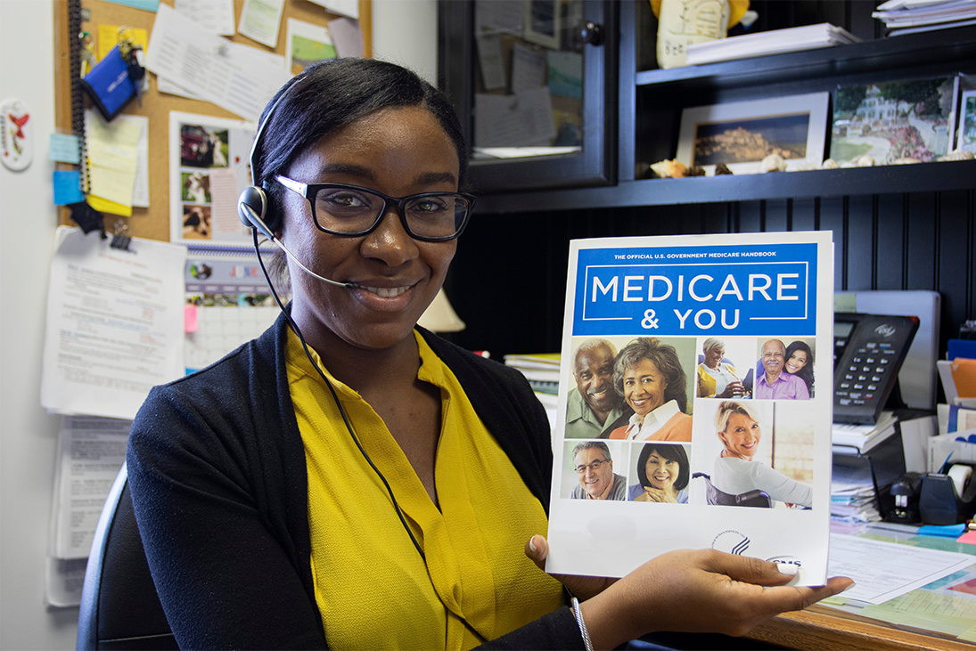 Woman displaying Medicare booklet