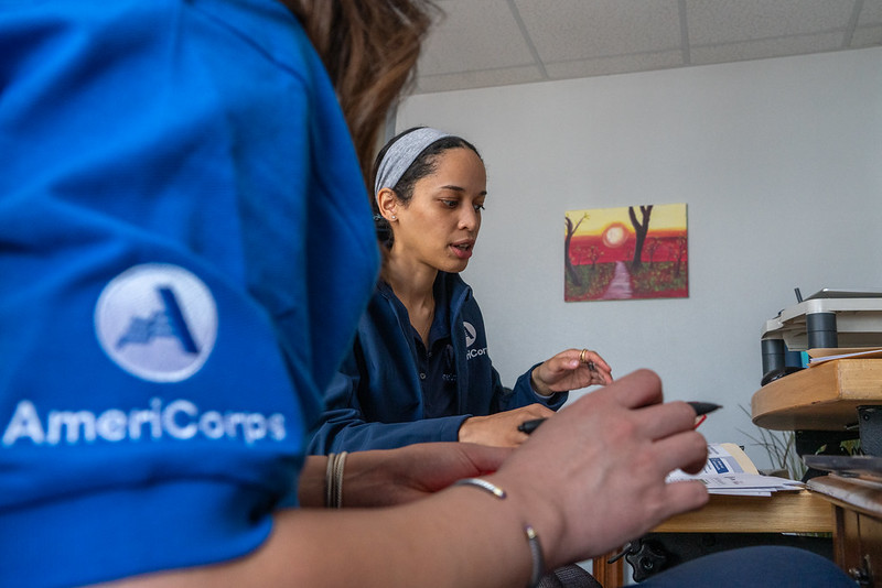 Two Americorps VISTA volunteers converse