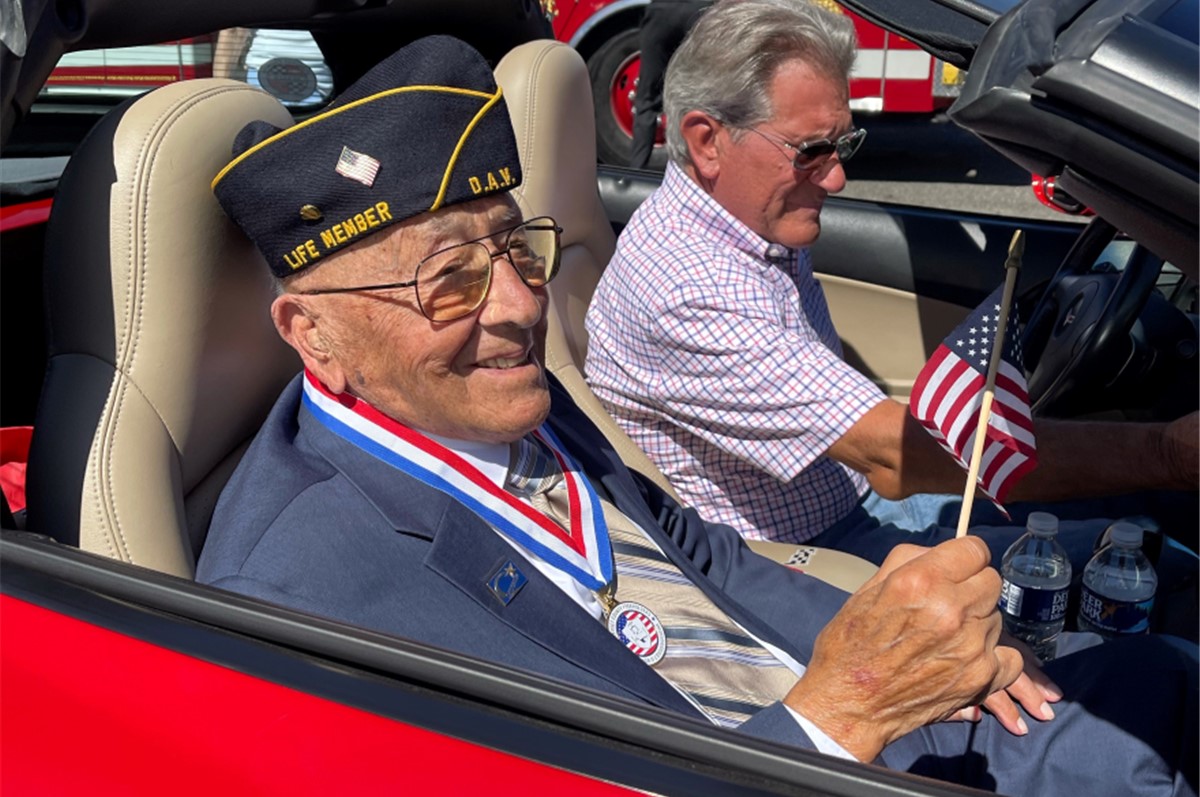 Veteran rides in car in a parade